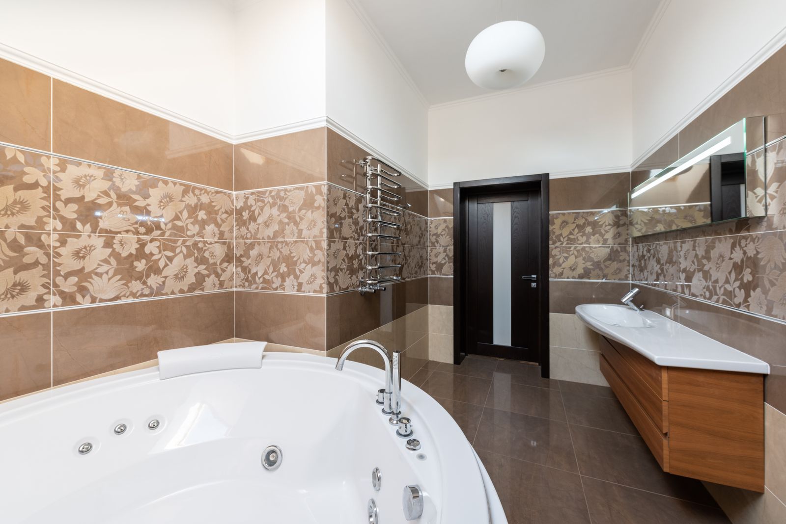 Contemporary bathroom with a round soaking tub and wood vanity