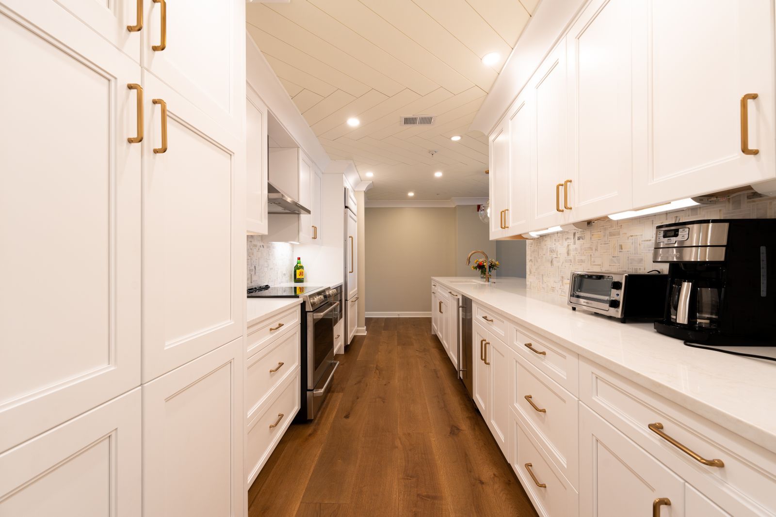 Bright kitchen with white cabinets and wood floors