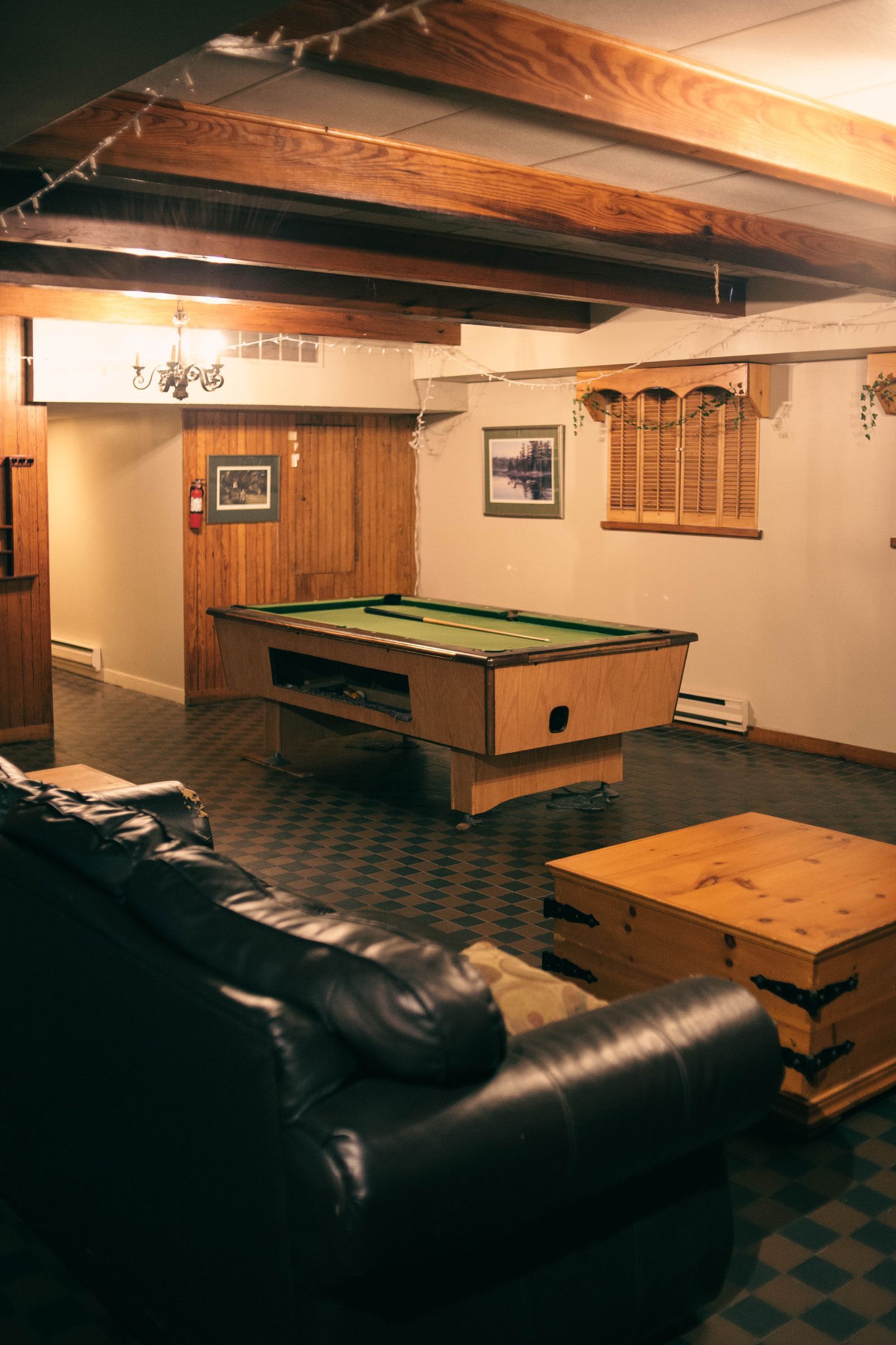 Basement games room with a pool table and wood panelling