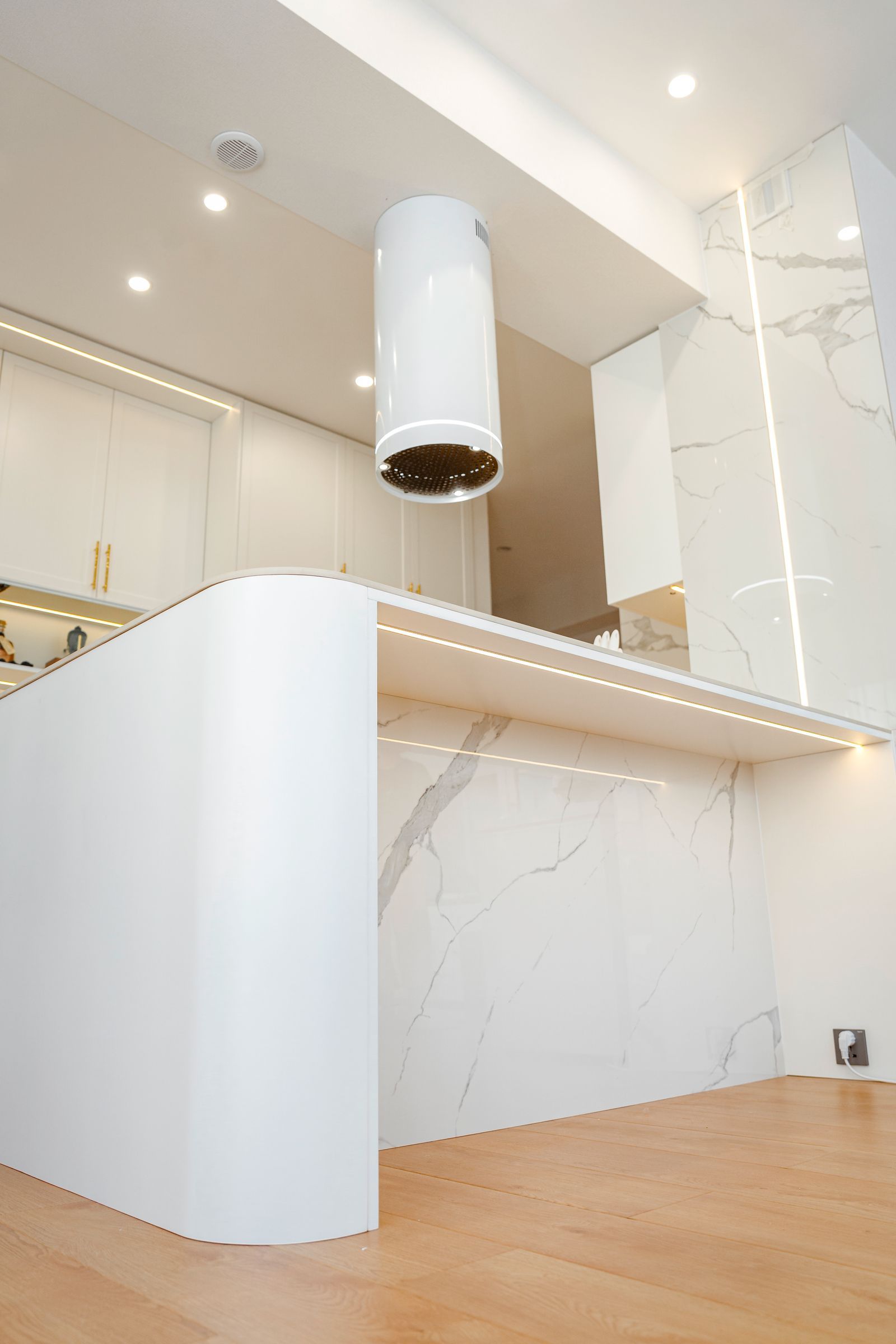 Kitchen with white marble counters and modern fixtures